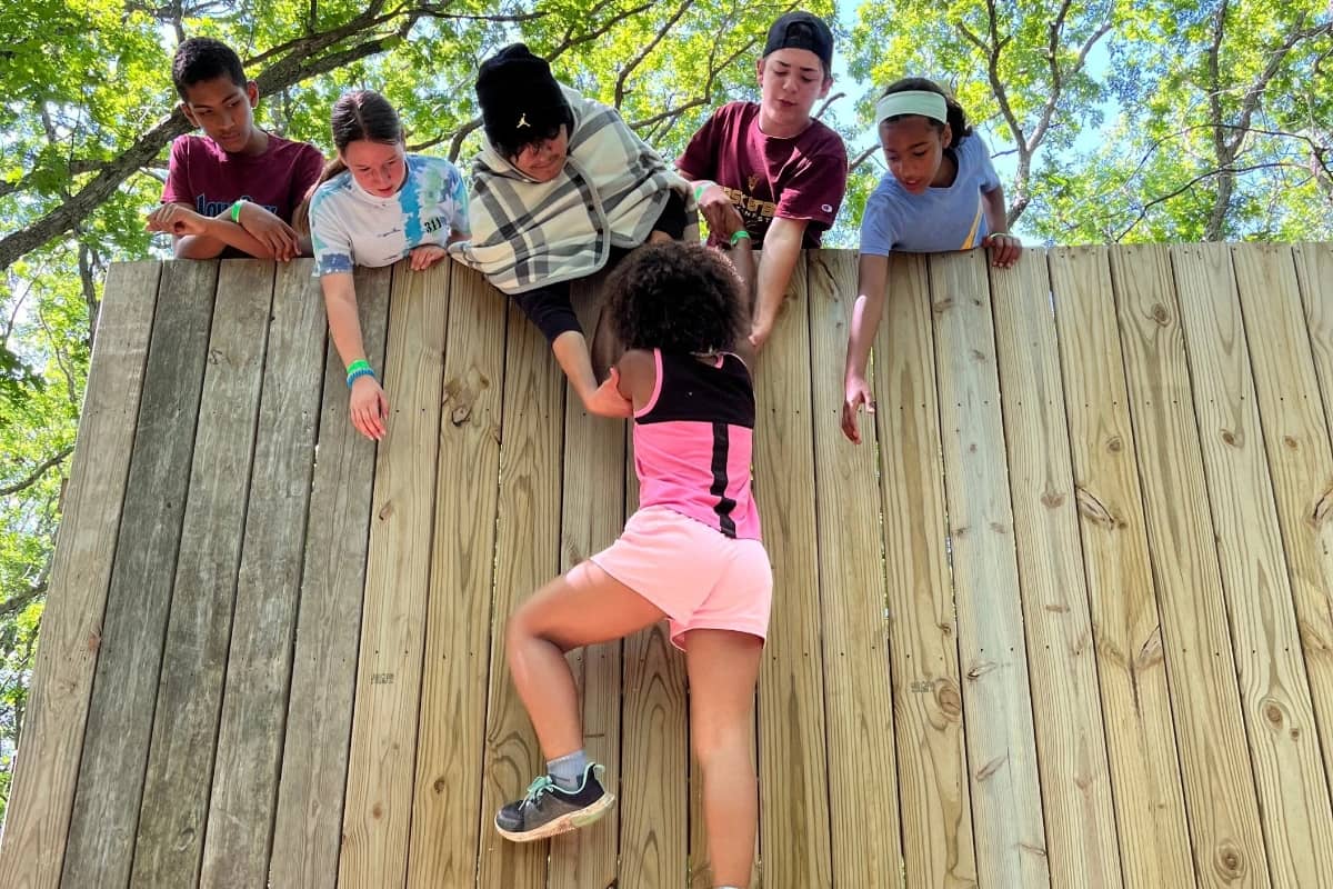Girl climbing wall at Camp Fire Iowa