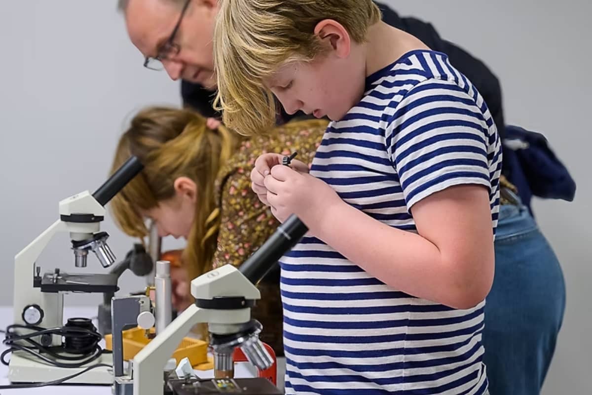 Student using a microscope at Experiment PDX camps