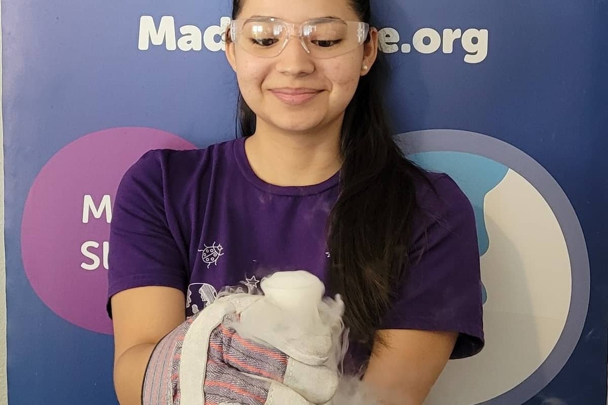 Girl holding science flask