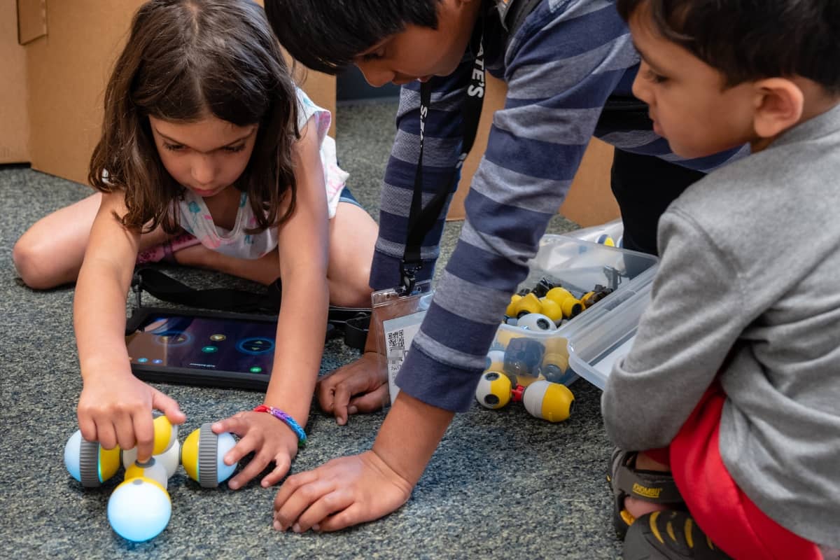 Kids playing with toy robots at Steve & Kate's Camp